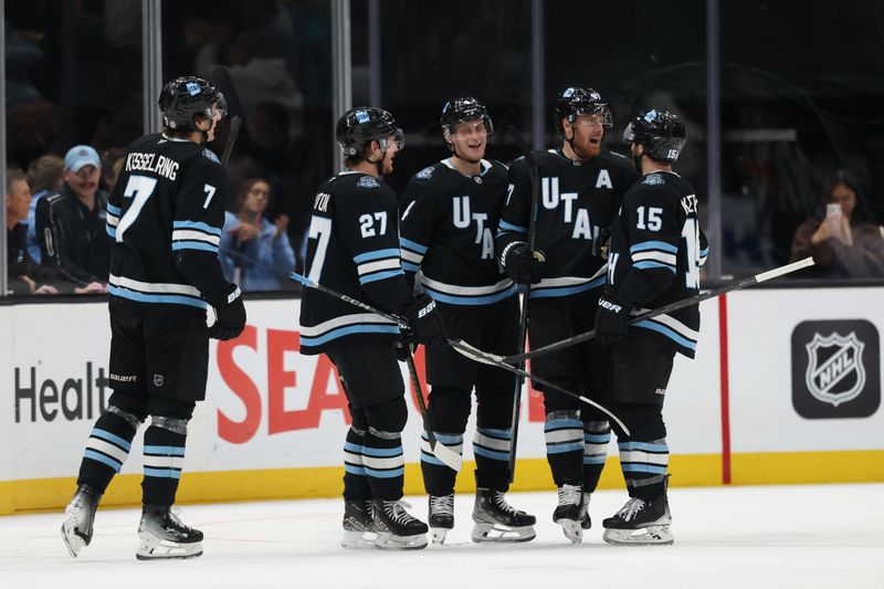 Nov 13, 2024; Salt Lake City, Utah, USA; The Utah Hockey Club celebrates a goal by center Nick Bjugstad (17) against the Carolina Hurricanes during the third period at Delta Center. Mandatory Credit: Rob Gray-Imagn Images