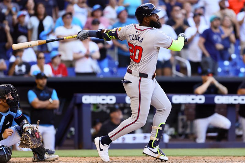 Apr 14, 2024; Miami, Florida, USA; Atlanta Braves designated hitter Marcell Ozuna (20) hits a two-run home run against the Miami Marlins during the ninth inning at loanDepot Park. Mandatory Credit: Sam Navarro-USA TODAY Sports