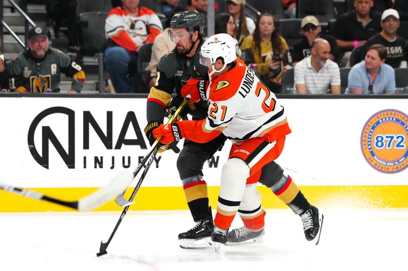 Oct 13, 2024; Las Vegas, Nevada, USA; Vegas Golden Knights right wing Mark Stone (61) makes a pass behind Anaheim Ducks center Isac Lundestrom (21) during the second period at T-Mobile Arena. Mandatory Credit: Stephen R. Sylvanie-Imagn Images