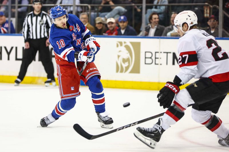 Apr 15, 2024; New York, New York, USA;  New York Rangers left wing Artemi Panarin (10) attempts a shot on goal past Ottawa Senators left wing Parker Kelly (27) in the third period at Madison Square Garden. Mandatory Credit: Wendell Cruz-USA TODAY Sports