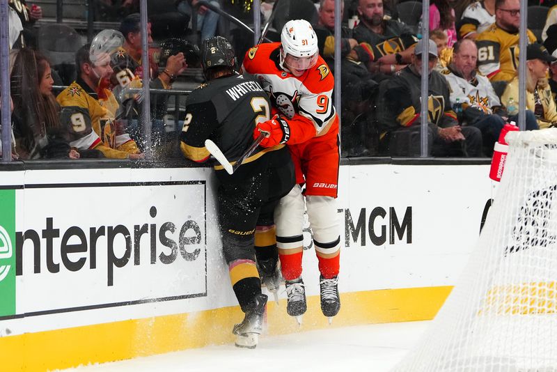 Oct 13, 2024; Las Vegas, Nevada, USA; Anaheim Ducks center Leo Carlsson (91) checks Vegas Golden Knights defenseman Zach Whitecloud (2) during the third period at T-Mobile Arena. Mandatory Credit: Stephen R. Sylvanie-Imagn Images