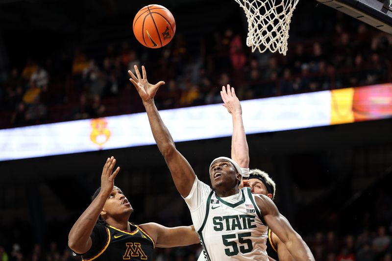 Dec 4, 2024; Minneapolis, Minnesota, USA; Michigan State Spartans forward Coen Carr (55) and Minnesota Golden Gophers forward Frank Mitchell (00) jump for the ball during the second half at Williams Arena. Mandatory Credit: Matt Krohn-Imagn Images