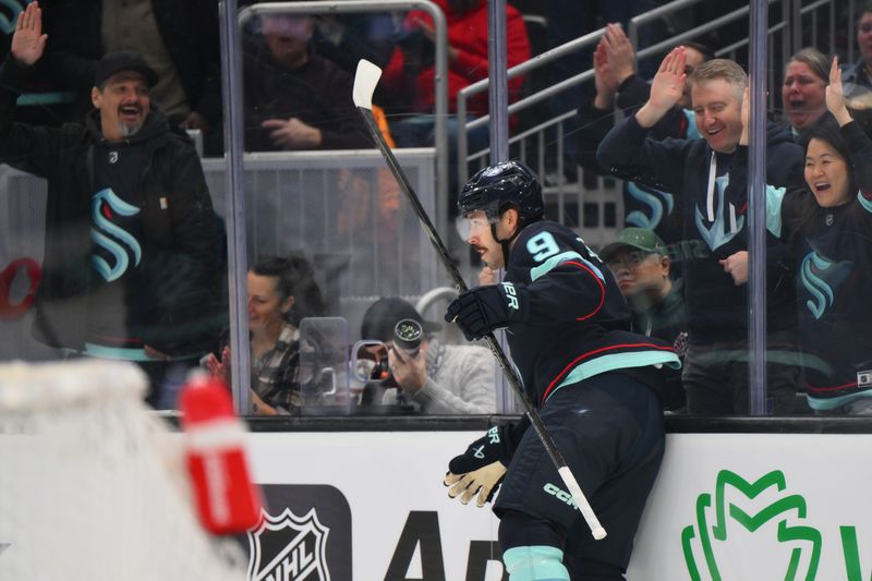 Jan 30, 2025; Seattle, Washington, USA; Seattle Kraken defenseman Adam Larsson (6) slides along the glass after scoring a goal against the San Jose Sharks during the first period at Climate Pledge Arena. Mandatory Credit: Steven Bisig-Imagn Images