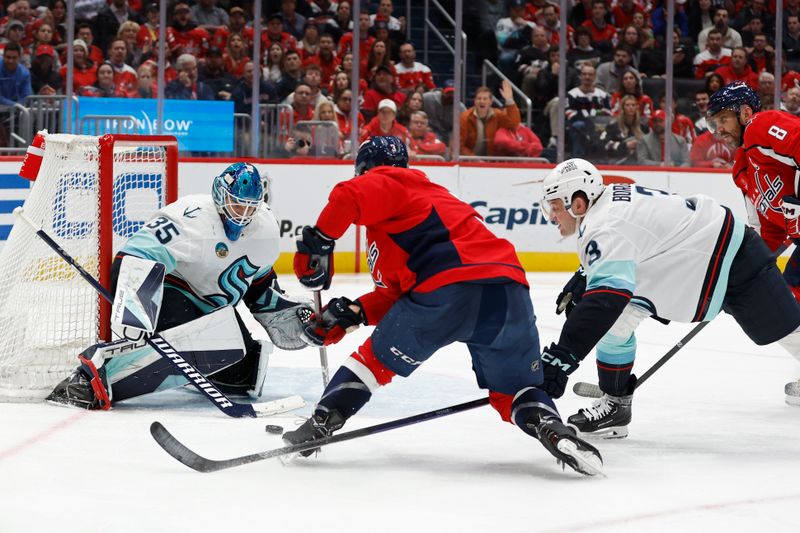 Jan 11, 2024; Washington, District of Columbia, USA; Seattle Kraken goaltender Joey Daccord (35) makes a save on Washington Capitals defenseman Nick Jensen (3) as Kraken defenseman Will Borgen (3) defends in the third period at Capital One Arena. Mandatory Credit: Geoff Burke-USA TODAY Sports