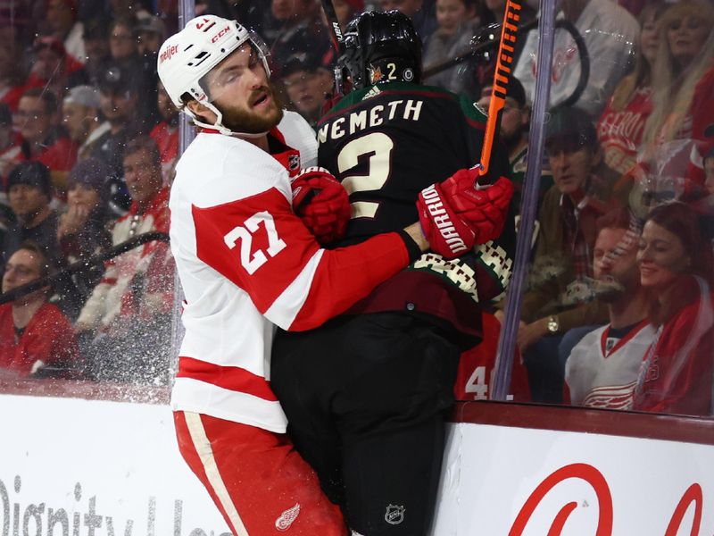 Jan 17, 2023; Tempe, Arizona, USA; Detroit Red Wings center Michael Rasmussen (27) checks Arizona Coyotes defenseman Patrik Nemeth (2) into the boards in the first period at Mullett Arena. Mandatory Credit: Mark J. Rebilas-USA TODAY Sports