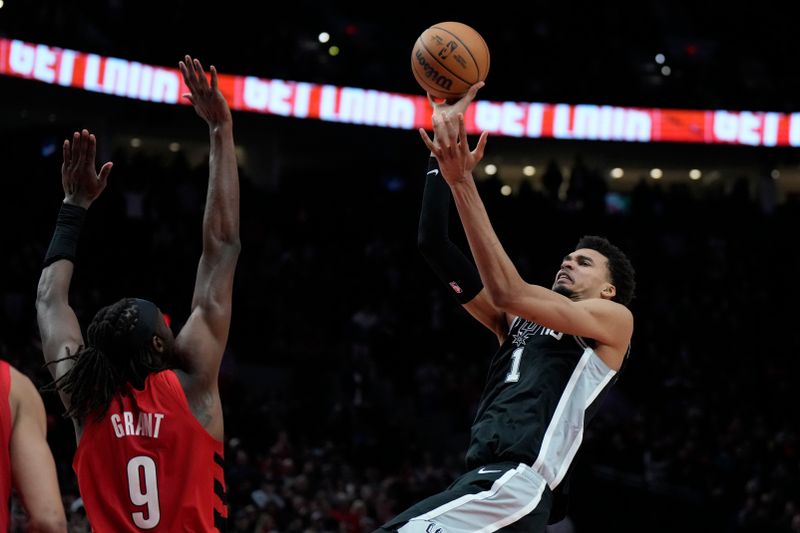 PORTLAND, OREGON - DECEMBER 13: Victor Wembanyama #1 of the San Antonio Spurs is fouled while shooting by Jerami Grant #9 of the Portland Trail Blazers during the second half at Moda Center on December 13, 2024 in Portland, Oregon. NOTE TO USER: User expressly acknowledges and agrees that, by downloading and or using this photograph, User is consenting to the terms and conditions of the Getty Images License Agreement. (Photo by Soobum Im/Getty Images)