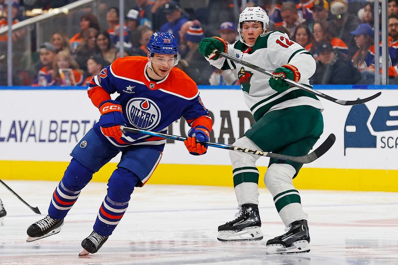 Nov 21, 2024; Edmonton, Alberta, CAN; Edmonton Oilers forward Vasily Podkolzin (92) and Minnesota Wild forward Matt Boldy (12) looks for a loose puck during the first period at Rogers Place. Mandatory Credit: Perry Nelson-Imagn Images