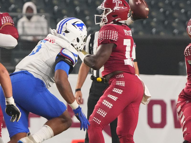 Oct 20, 2023; Philadelphia, Pennsylvania, USA; Temple Owls quarterback Quincy Patterson (16) throws the ball with SMU Mustangs defensive end Elijah Roberts (5) applying pressure during the first half at Lincoln Financial Field. Mandatory Credit: Gregory Fisher-USA TODAY Sports