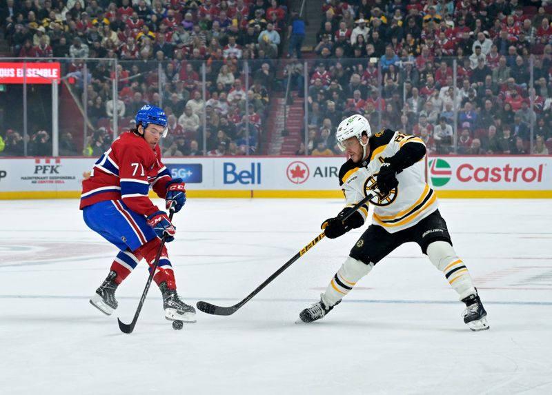 Apr 3, 2025; Montreal, Quebec, CAN; Boston Bruins forward David Pastrnak (88) plays the puck and Montreal Canadiens forward Jake Evans (71) defends during the first period at the Bell Centre. Mandatory Credit: Eric Bolte-Imagn Images