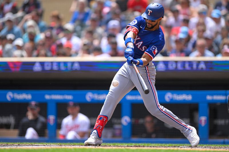 May 25, 2024; Minneapolis, Minnesota, USA;  Texas Rangers outfielder Leody Taveras (3) hits a single against the Minnesota Twins during the second inning at Target Field. Mandatory Credit: Nick Wosika-USA TODAY Sports