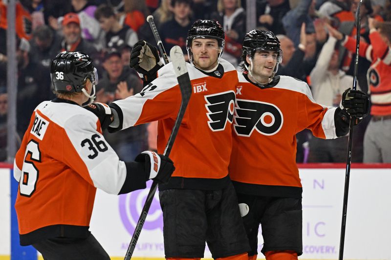 Nov 20, 2025; Philadelphia, Pennsylvania, USA; Philadelphia Flyers right wing Tyson Foerster (71) celebrates his goal with defenseman Emil Andrae (36) and defenseman Jamie Drysdale (9) against the St. Louis Blues during the third period at Xfinity Mobile Arena. Mandatory Credit: Eric Hartline-Imagn Images
