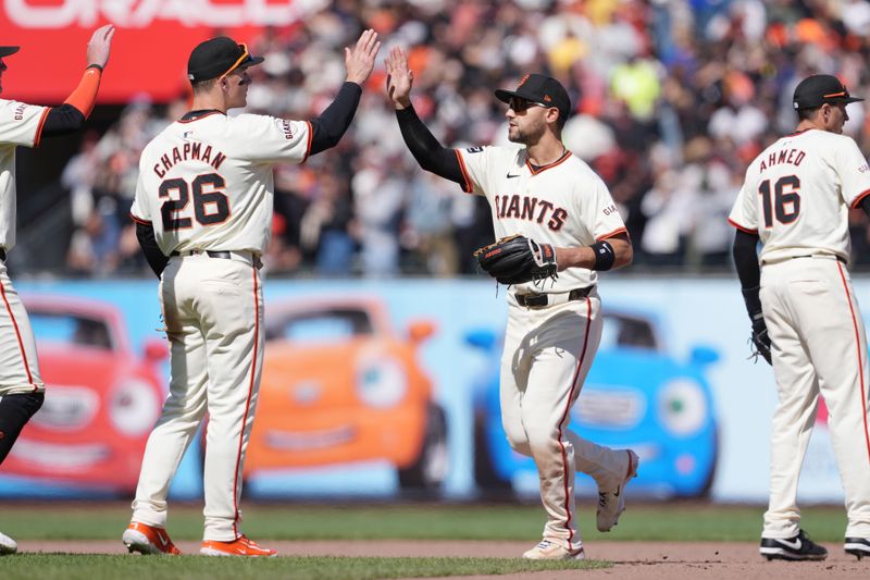 Apr 7, 2024; San Francisco, California, USA; San Francisco Giants third baseman Matt Chapman (26) and left fielder Michael Conforto (center right) celebrate after defeating the San Diego Padres at Oracle Park. Mandatory Credit: Darren Yamashita-USA TODAY Sports