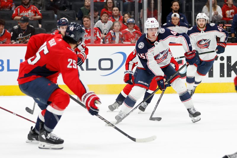 Sep 27, 2024; Washington, District of Columbia, USA; Columbus Blue Jackets center Gavin Brindley (45) skates with the puck as Washington Capitals defenseman Ethan Bear (25) defends in the second period at Capital One Arena. Mandatory Credit: Geoff Burke-Imagn Images