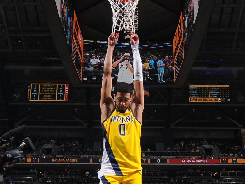 INDIANAPOLIS, IN - APRIL 14: Tyrese Haliburton #0 of the Indiana Pacers hangs onto the net before the game against the Atlanta Hawks on April 14, 2024 at Gainbridge Fieldhouse in Indianapolis, Indiana. NOTE TO USER: User expressly acknowledges and agrees that, by downloading and or using this Photograph, user is consenting to the terms and conditions of the Getty Images License Agreement. Mandatory Copyright Notice: Copyright 2024 NBAE (Photo by Ron Hoskins/NBAE via Getty Images)