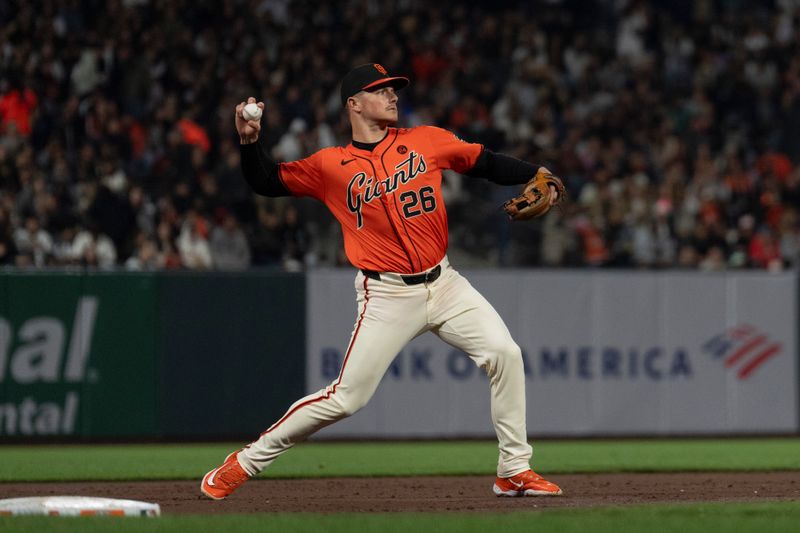 Sep 13, 2024; San Francisco, California, USA;  San Francisco Giants third base Matt Chapman (26) throws the ball during the fourth inning against the San Diego Padres at Oracle Park. Mandatory Credit: Stan Szeto-Imagn Images