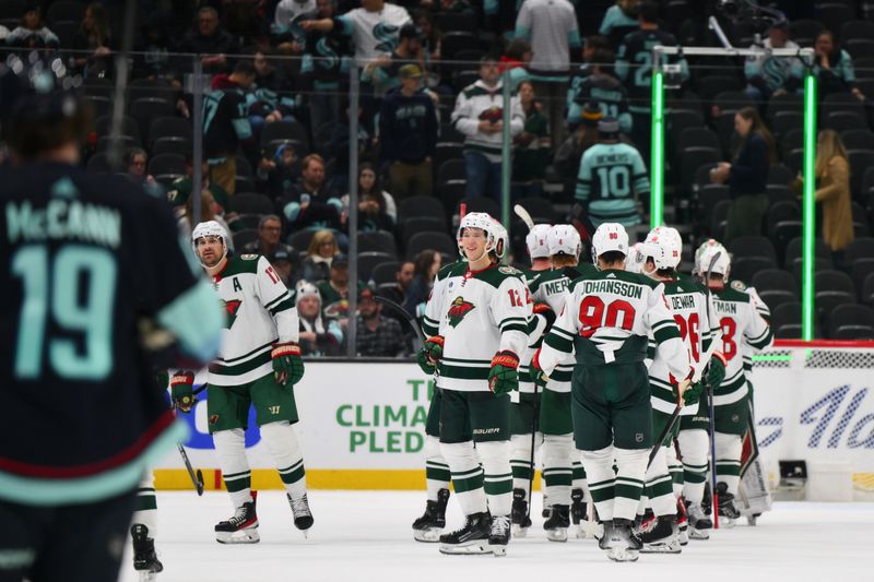 Dec 10, 2023; Seattle, Washington, USA; The Minnesota Wild celebrate after defeating the Seattle Kraken at Climate Pledge Arena. Mandatory Credit: Steven Bisig-USA TODAY Sports