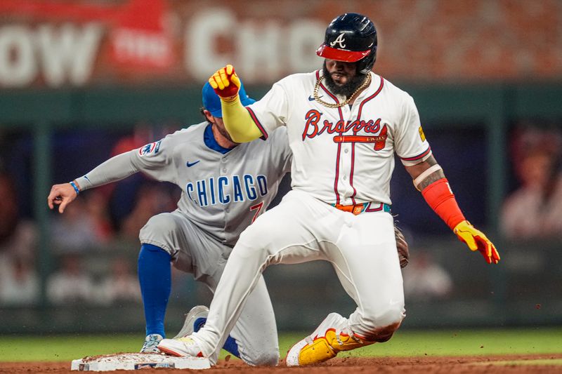 Sep 10, 2025; Cumberland, Georgia, USA; Atlanta Braves designated hitter Marcell Ozuna (20) slides in to second base ahead of a tag by Chicago Cubs shortstop Dansby Swanson (7) after hitting a double during the third inning at Truist Park. Mandatory Credit: Dale Zanine-Imagn Images