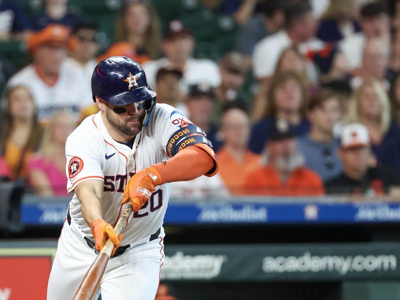 Jun 23, 2024; Houston, Texas, USA;  Houston Astros center fielder Chas McCormick (20) bunts and flies out for an out to end the third inning with two men in scoring position against the Baltimore Orioles at Minute Maid Park. Mandatory Credit: Thomas Shea-USA TODAY Sports