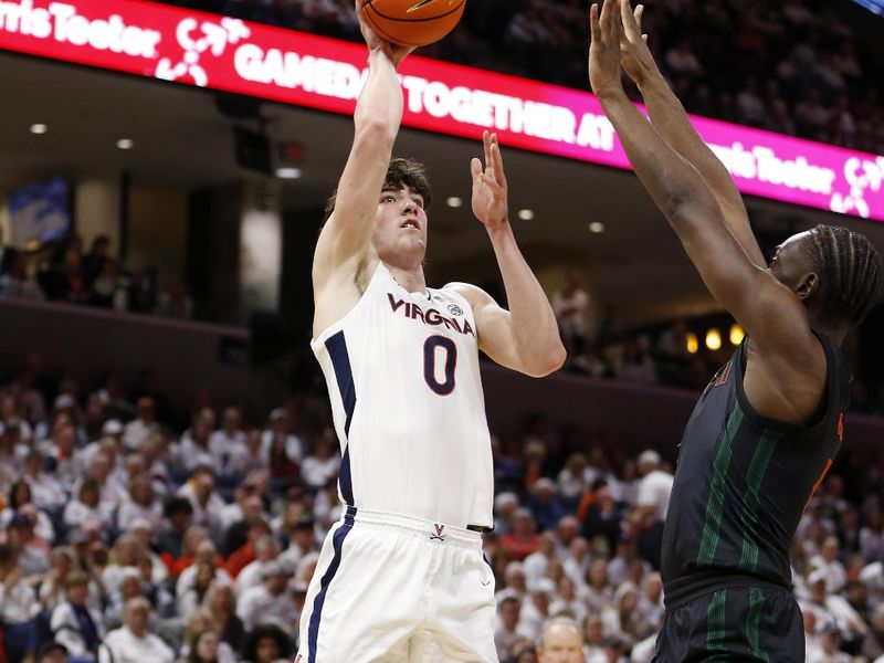 Feb 5, 2024; Charlottesville, Virginia, USA; Virginia Cavaliers forward Blake Buchanan (0) shoots the ball over Miami (Fl) Hurricanes center Michael Nwoko (1) during the second half at John Paul Jones Arena. Mandatory Credit: Amber Searls-USA TODAY Sports