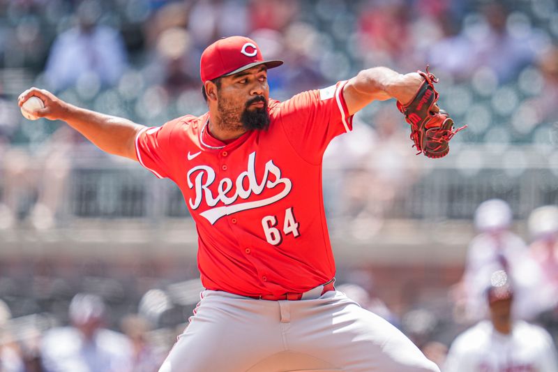 Jul 24, 2024; Cumberland, Georgia, USA; Cincinnati Reds relief pitcher Tony Santillan (64) pitches against the Atlanta Braves during the eighth inning at Truist Park. Mandatory Credit: Dale Zanine-USA TODAY Sports