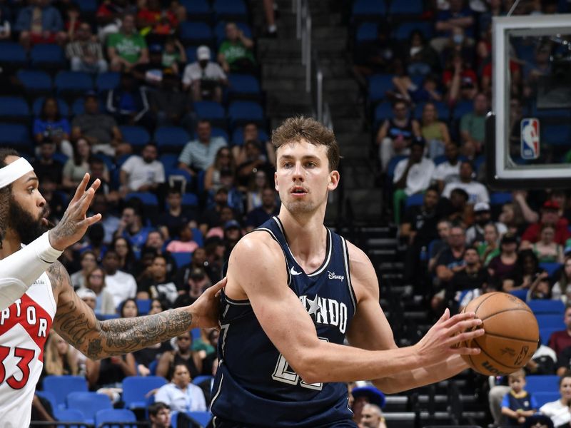 ORLANDO, FL - MARCH 17: Franz Wagner #22 of the Orlando Magic looks to pass the ball during the game against the Toronto Raptors on March 17, 2024 at the Kia Center in Orlando, Florida. NOTE TO USER: User expressly acknowledges and agrees that, by downloading and or using this photograph, User is consenting to the terms and conditions of the Getty Images License Agreement. Mandatory Copyright Notice: Copyright 2024 NBAE (Photo by Fernando Medina/NBAE via Getty Images)