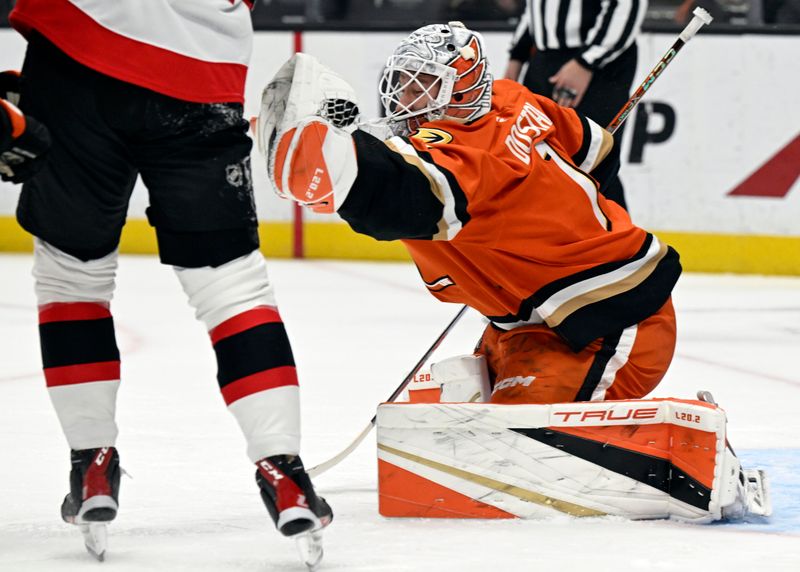 Dec 1, 2024; Anaheim, California, USA;  Anaheim Ducks goaltender Lukas Dostal (1) catches a shot against the Ottawa Senators during the first period at Honda Center. Mandatory Credit: Alex Gallardo-Imagn Images