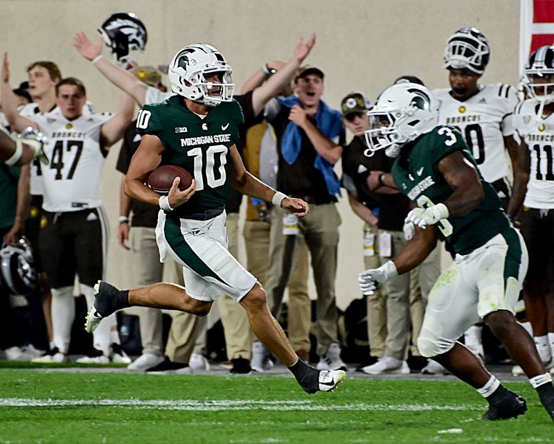 Sep 2, 2022; East Lansing, Michigan, USA; Michigan State Spartans quarterback Payton Thorne (10) runs for a first down at Spartan Stadium during their game against Western Michigan University. Mandatory Credit: Dale Young-USA TODAY Sports
