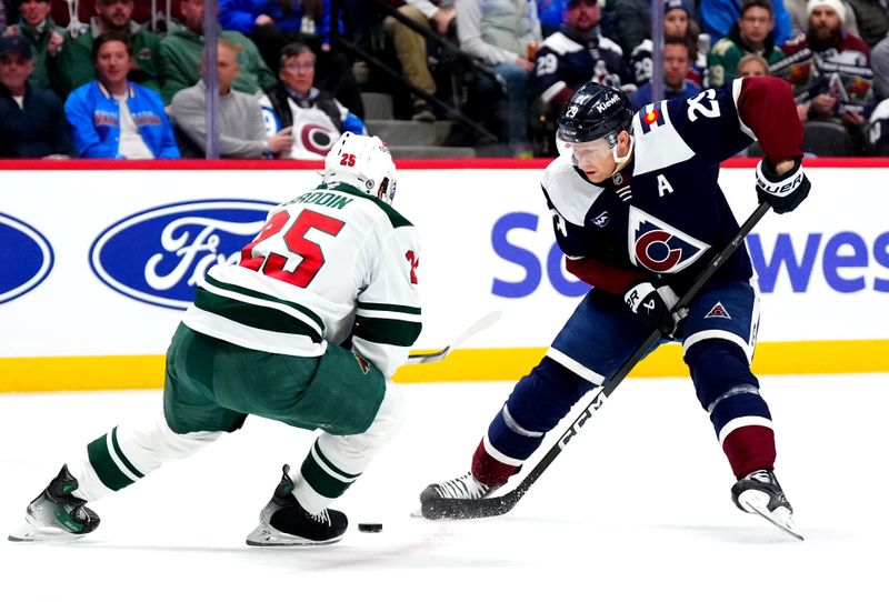 Feb 28, 2025; Denver, Colorado, USA; Minnesota Wild defenseman Jonas Brodin (25) defends on Colorado Avalanche center Nathan MacKinnon (29) in the second period at Ball Arena. Mandatory Credit: Ron Chenoy-Imagn Images