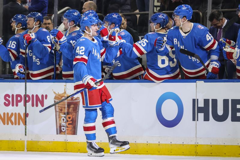 Dec 13, 2025; New York, New York, USA;  New York Rangers center Noah Laba (42) celebrates with his teammates after scoring a goal in the first period against the Montréal Canadiens at Madison Square Garden. Mandatory Credit: Wendell Cruz-Imagn Images