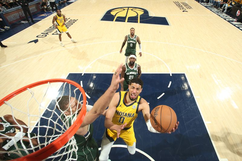 INDIANAPOLIS, IN - APRIL 26: Tyrese Haliburton #0 of the Indiana Pacers drives to the basket during the game against the Milwaukee Bucks during Round 1 Game 3 of the 2024 NBA Playoffs on April 26, 2024 at Gainbridge Fieldhouse in Indianapolis, Indiana. NOTE TO USER: User expressly acknowledges and agrees that, by downloading and or using this Photograph, user is consenting to the terms and conditions of the Getty Images License Agreement. Mandatory Copyright Notice: Copyright 2023 NBAE (Photo by Nathaniel S. Butler/NBAE via Getty Images)