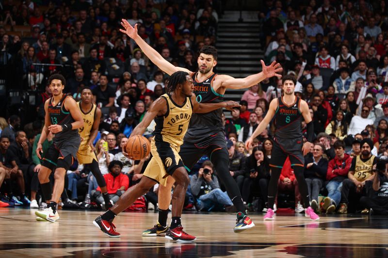 TORONTO, CANADA - APRIL 7: Tristan Vukcevic #00 of the Washington Wizards plays defense against Immanuel Quickley #5 of the Toronto Raptors on April 7, 2024 at the Scotiabank Arena in Toronto, Ontario, Canada.  NOTE TO USER: User expressly acknowledges and agrees that, by downloading and or using this Photograph, user is consenting to the terms and conditions of the Getty Images License Agreement.  Mandatory Copyright Notice: Copyright 2024 NBAE (Photo by Vaughn Ridley/NBAE via Getty Images)