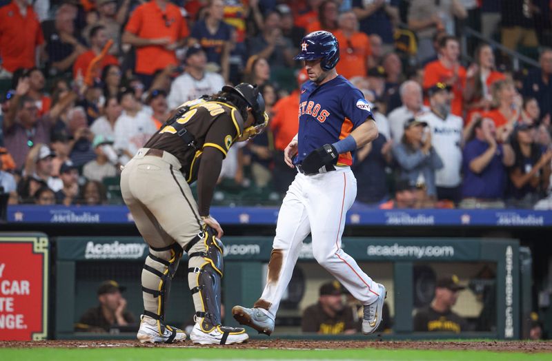 Sep 10, 2023; Houston, Texas, USA; Houston Astros third baseman Alex Bregman (2) scores a run past San Diego Padres catcher Luis Campusano (12) during the sixth inning at Minute Maid Park. Mandatory Credit: Troy Taormina-USA TODAY Sports