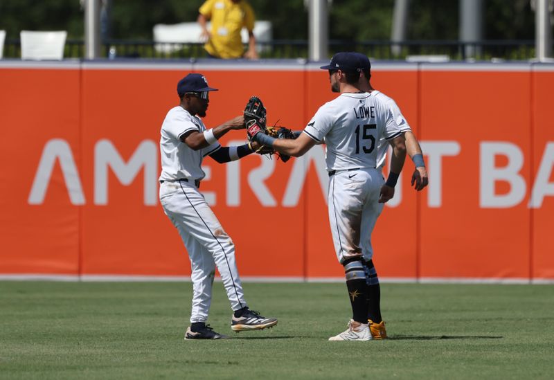May 28, 2025; Tampa, FL, USA;Tampa Bay Rays outfielder Chandler Simpson (14), outfielder Josh Lowe (15)  and outfielder Kameron Misner (26) celebrate after they beat the Minnesota Twins at George M. Steinbrenner Field. Mandatory Credit: Kim Klement Neitzel-Imagn Images