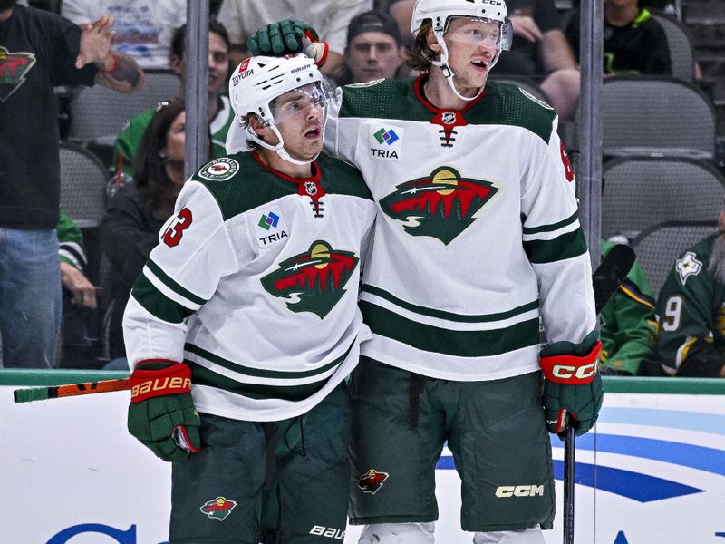 Sep 29, 2022; Dallas, Texas, USA; Minnesota Wild center Sam Steel (13) and defenseman Andrej Sustr (62) celebrates scoring a goal against Dallas Stars goaltender Anton Khudobin (35) during the third period at the American Airlines Center. Mandatory Credit: Jerome Miron-USA TODAY Sports