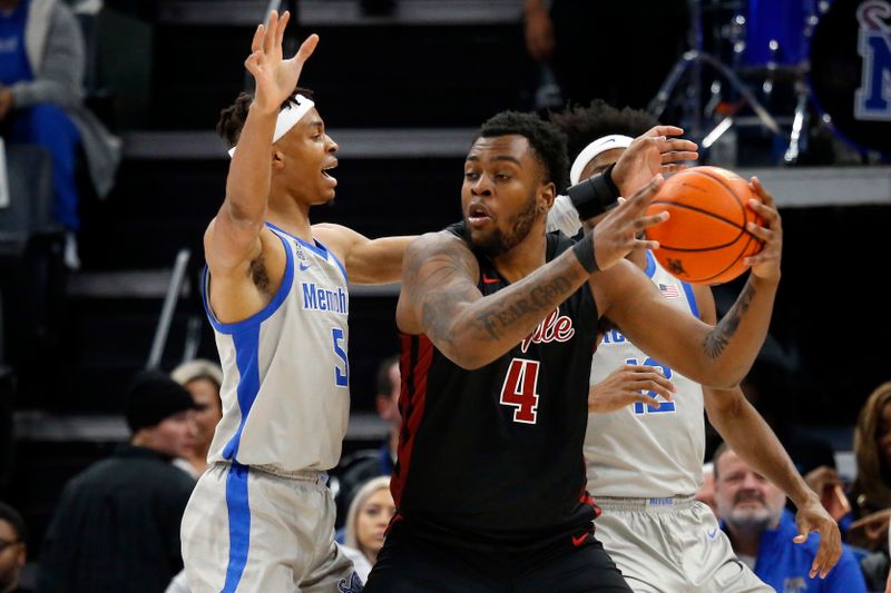 Feb 12, 2023; Memphis, Tennessee, USA; Temple Owls forward Jamille Reynolds (4) spins toward the basket as Memphis Tigers forward Kaodirichi Akobundu-Ehiogu (5) defends during the first half at FedExForum. Mandatory Credit: Petre Thomas-USA TODAY Sports