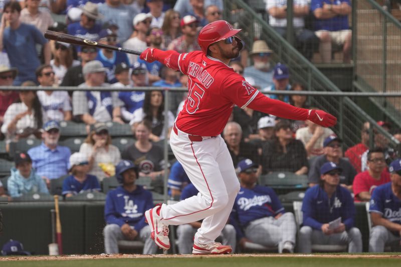 Mar 5, 2025; Tempe, Arizona, USA; Los Angeles Angels catcher Travis d'Arnaud (25) hits against the Los Angeles Dodgers in the first inning at Tempe Diablo Stadium. Mandatory Credit: Rick Scuteri-Imagn Images