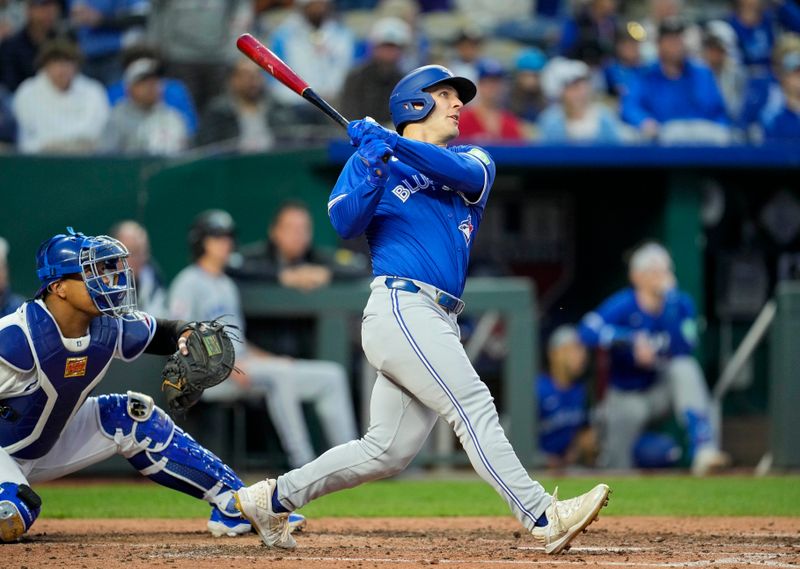 Apr 22, 2024; Kansas City, Missouri, USA; Toronto Blue Jays right fielder Daulton Varsho (25) hits a home run against the Kansas City Royals during the sixth inning at Kauffman Stadium. Mandatory Credit: Jay Biggerstaff-USA TODAY Sports