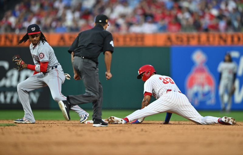 Aug 17, 2024; Philadelphia, Pennsylvania, USA; Philadelphia Phillies infielder Edmundo Sosa (33) steals second base against Washington Nationals infielder CJ Abrams (5) in the third inning at Citizens Bank Park. Mandatory Credit: Kyle Ross-USA TODAY Sports