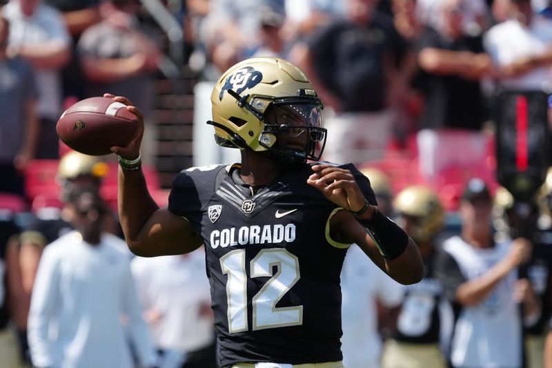 Sep 11, 2021; Denver, Colorado, USA; Colorado Buffaloes quarterback Brendon Lewis (12) prepares to pass the ball in the first quarter against the Texas A&M Aggies at Empower Field at Mile High. Mandatory Credit: Ron Chenoy-USA TODAY Sports