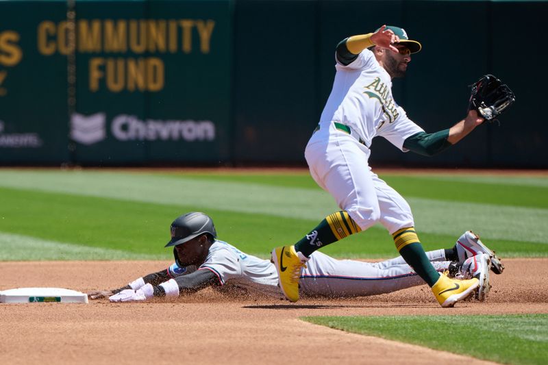 May 5, 2024; Oakland, California, USA; Miami Marlins outfielder Jazz Chisholm Jr. (2) steals second base against Oakland Athletics infielder Abraham Toro (31) during the first inning at Oakland-Alameda County Coliseum. Mandatory Credit: Robert Edwards-USA TODAY Sports