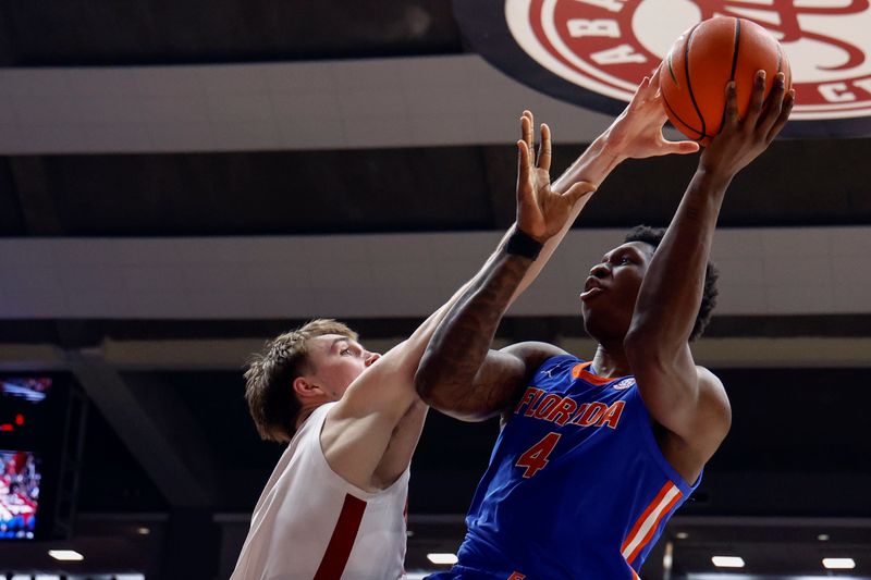 Feb 21, 2024; Tuscaloosa, Alabama, USA; Alabama Crimson Tide forward Grant Nelson (2) blocks the shot attempt of Florida Gators forward Tyrese Samuel (4) during the second half at Coleman Coliseum. Mandatory Credit: Butch Dill-USA TODAY Sports