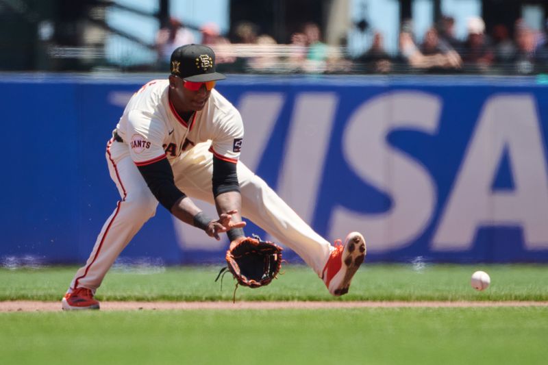 May 19, 2024; San Francisco, California, USA; San Francisco Giants infielder Marco Luciano (37) fields a ground ball against the Colorado Rockies during the first inning at Oracle Park. Mandatory Credit: Robert Edwards-USA TODAY Sports