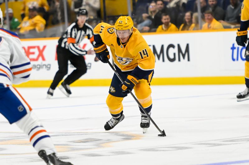 Oct 17, 2024; Nashville, Tennessee, USA;  Nashville Predators center Gustav Nyquist (14) skates with the puck against the Edmonton Oilers during the first period at Bridgestone Arena. Mandatory Credit: Steve Roberts-Imagn Images