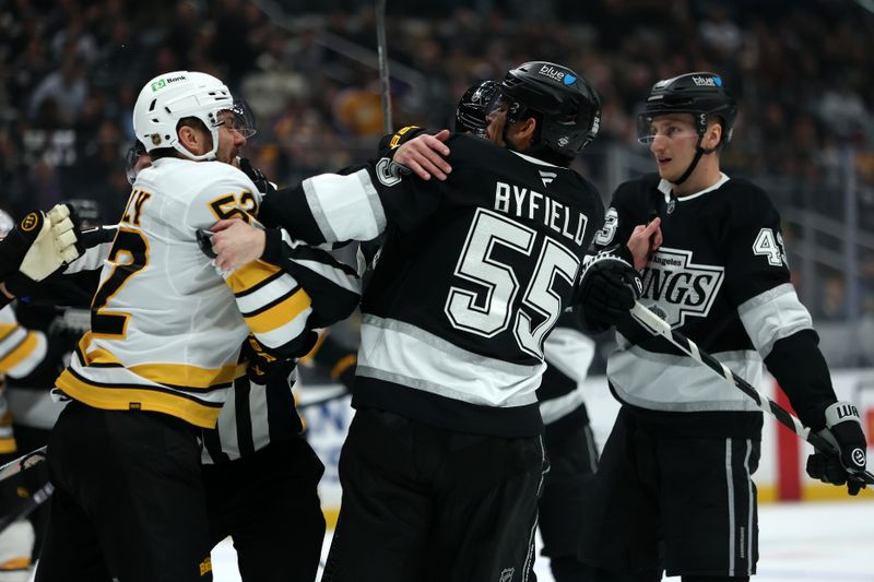 Nov 21, 2025; Los Angeles, California, USA;  Boston Bruins center Sean Kuraly (52) and Los Angeles Kings right wing Quinton Byfield (55) scuffle during the second period at Crypto.com Arena. Mandatory Credit: Kiyoshi Mio-Imagn Images