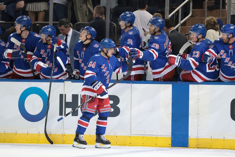 Sep 23, 2025; New York, New York, USA; New York Rangers right wing Trey Fix-Wolansky (64) celebrates his goal with teammates during the first period of a preseason game at Madison Square Garden. Mandatory Credit: Vincent Carchietta-Imagn Images