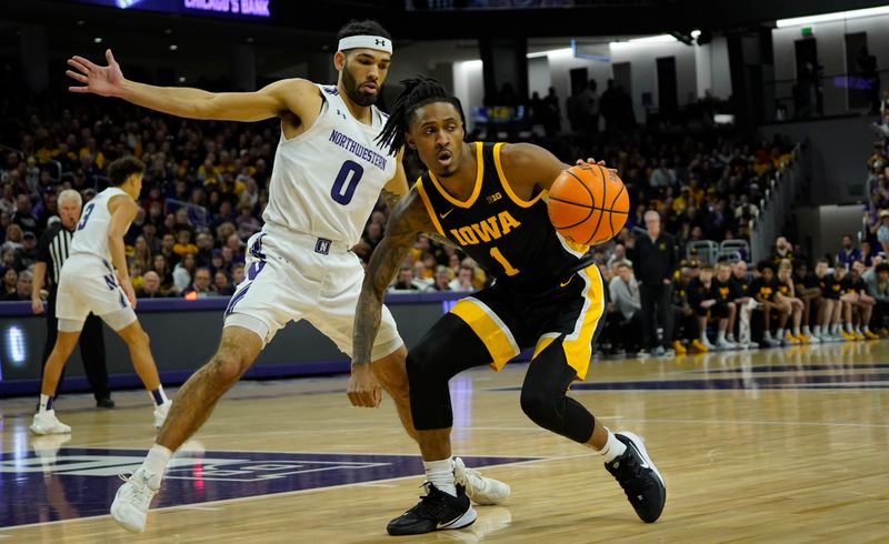 Feb 19, 2023; Evanston, Illinois, USA; Northwestern Wildcats guard Boo Buie (0) defends Iowa Hawkeyes guard Ahron Ulis (1) during the first half at Welsh-Ryan Arena. Mandatory Credit: David Banks-USA TODAY Sports