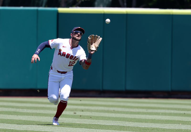 Jul 28, 2024; Anaheim, California, USA;  Los Angeles Angels center fielder Kevin Pillar (12) catches a fly ball during the first inning against the Oakland Athletics at Angel Stadium. Mandatory Credit: Kiyoshi Mio-USA TODAY Sports