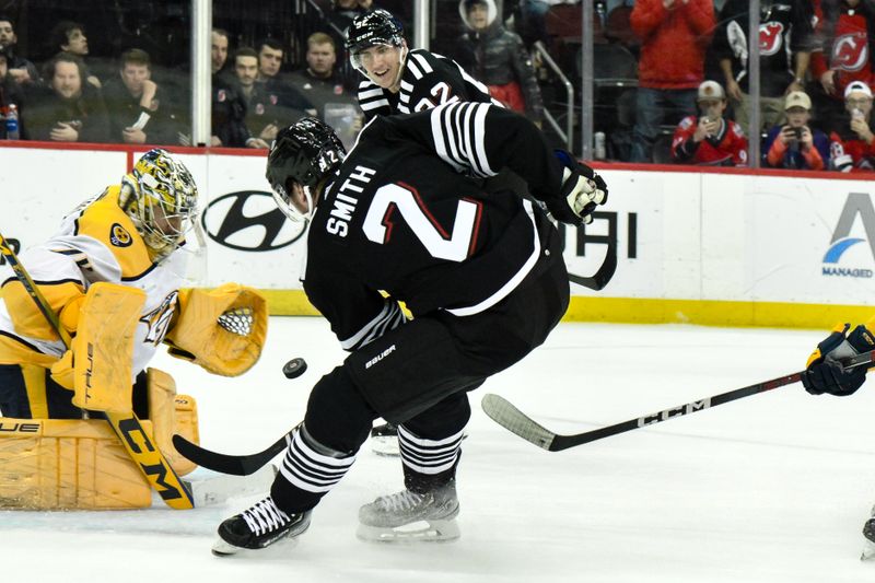 Apr 7, 2024; Newark, New Jersey, USA; Nashville Predators goaltender Juuse Saros (74) makes a save against New Jersey Devils defenseman Brendan Smith (2) during overtime at Prudential Center. Mandatory Credit: John Jones-USA TODAY Sports