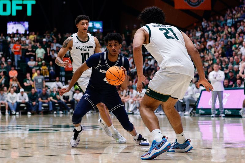 Mar 1, 2025; Fort Collins, Colorado, USA; Utah State Aggies guard Ian Martinez (4) controls the ball against Colorado State Rams forward Rashaan Mbemba (21) and guard Nique Clifford (10) in the second half at Moby Arena. Mandatory Credit: Isaiah J. Downing-Imagn Images