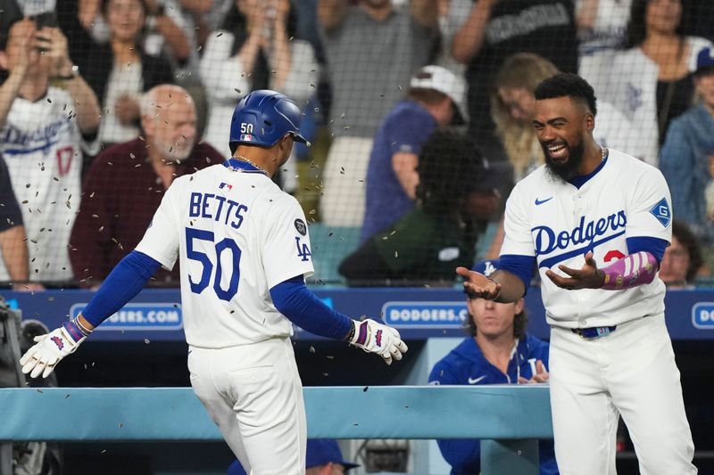 Sep 9, 2025; Los Angeles, California, USA;  Los Angeles Dodgers shortstop Mookie Betts (50) celebrates his home run with right fielder Teoscar Hernandez (37) against the Colorado Rockies during the third inning of the game at Dodger Stadium. Mandatory Credit: Kirby Lee-Imagn Images